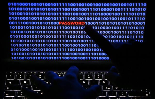 FILED - 05 November 2013, North Rhine-Westphalia, Cologne: FILE - ILLUSTRATION - An illustrated archive picture dated 05 November 2013 shows a finger pointing to the word 'password' which is displayed between lines of binary code on a computer screen in Cologne, Germany. The German Federal Criminal Police Office (BKA) has made the fight against computer crime the central topic of its traditional autumn conference in Wiesbaden this year. Photo\ OLIVER BERG Photo: picture alliance / dpa