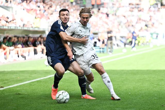 23 August 2026, Rheinland-Pfalz, Mainz: Schott Mainz's Nils Gans (L) and Borussia Moenchengladbach's Hugo Bolin battle for the ball during the German DFB Cup first round soccer match between Schott Mainz and Borussia Moenchengladbach at Mewa Arena. Photo: Florian Wiegand/dpa - WICHTIGER HINWEIS: Gemäß den Vorgaben der Bundesliga bzw. des DFB Deutscher Fußball-Bund ist es untersagt, in dem Stadion und/oder vom Spiel angefertigte Fotoaufnahmen in Form von Sequenzbildern und/oder videoähnlichen Fotostrecken zu verwerten bzw. verwerten zu lassen.