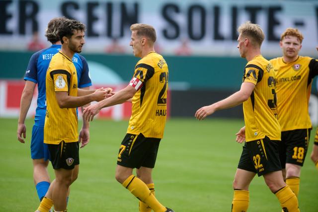 23 August 2026, North Rhine-Westphalia, Muenster: Dynamo Dresden's Niklas Hauptmann (2nd L) celebrates scoring his side's second goal with teammates during the German DFB Cup first round soccer match between Westfalia Rhynern and Dynamo Dresden at Preussenstadion. Photo: Bernd Thissen/dpa - WICHTIGER HINWEIS: Gemäß den Vorgaben der Bundesliga bzw. des DFB Deutscher Fußball-Bund ist es untersagt, in dem Stadion und/oder vom Spiel angefertigte Fotoaufnahmen in Form von Sequenzbildern und/oder videoähnlichen Fotostrecken zu verwerten bzw. verwerten zu lassen.