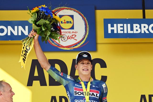 23 August 2026, Heilbronn: French rider Paul Magnier of Team Soudal Quick-Step celebrates on the podium after the fourth stage of the Tour of Germany cycling race, 156.5 km from Heilbronn to Heilbronn. Photo: Uli Deck/dpa
