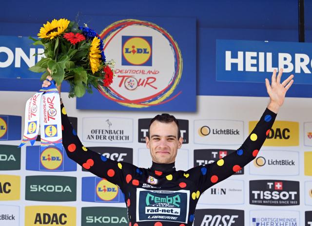 23 August 2026, Heilbronn: German rider Miguel Heidemann of Team Rembe/Rad-Net wearing the mountain jersey celebrates at the awards ceremony after the fourth stage of the Tour of Germany cycling race, 156.5 km from Heilbronn to Heilbronn. Photo: Uli Deck/dpa