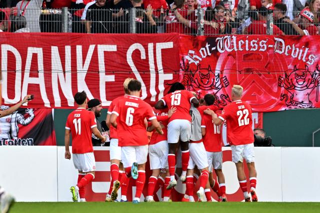 23 August 2026, North Rhine-Westphalia, Essen: Essen players celebrate their side's second goal during the German DFB Cup first round soccer match between Rot-Weiss Essen and FC St. Pauli at the Stadion an der Hafenstrasse. Photo: Anke Waelischmiller/dpa - WICHTIGER HINWEIS: Gemäß den Vorgaben der Bundesliga bzw. des DFB Deutscher Fußball-Bund ist es untersagt, in dem Stadion und/oder vom Spiel angefertigte Fotoaufnahmen in Form von Sequenzbildern und/oder videoähnlichen Fotostrecken zu verwerten bzw. verwerten zu lassen.