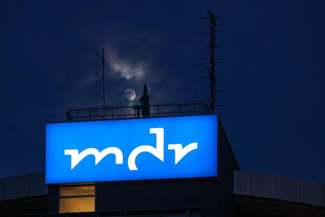 FILED - 10 February 2025, Saxony-Anhalt, Halle (Saale): FILE PHOTO - The moon shines over the programming department of Mitteldeutscher Rundfunk (MDR). Photo: Jan Woitas/dpa