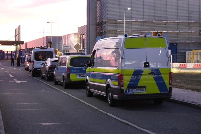 24 August 2026, Saxony, Schkeuditz: Police emergency vehicles are parked at Leipzig-Halle Airport. Photo: Sebastian Willnow/dpa