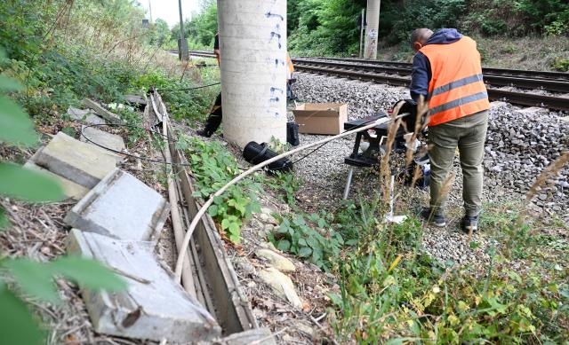 25 August 2026, Baden-Württemberg, Backnang: Workers are repairing damage to cables laid near railroad tracks. There is suspicion that the severed cables were the result of sabotage. Photo: Bernd Weißbrod/dpa
