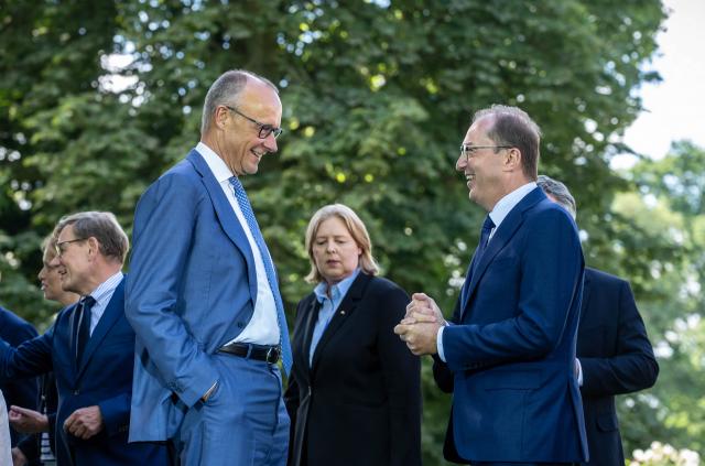 25 August 2026, Brandenburg, Neuhardenberg: German Chancellor Friedrich Merz (L) speaks with Alexander Dobrindt, German Minister of the Interior, after the group photo at the federal government's closed-door meeting in front of Neuhardenberg Castle. The Federal Cabinet is meeting here for two days. Photo: Michael Kappeler/dpa