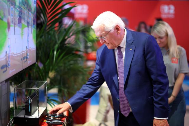 27 August 2026, North Rhine-Westphalia, Cologne: German President Frank-Walter Steinmeier picks up a controller at the Nintendo booth at Gamescom, the world's largest computer and video game trade show. Photo: Christoph Reichwein/dpa