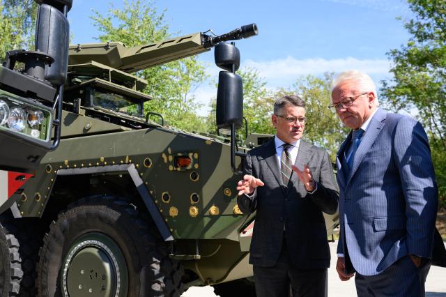 27 August 2026, Hesse, Kassel: Rheinmetall CEO Armin Papperger (R) explains the Boxer armored personnel carrier to Hesse's Minister President Boris Rhein on the Rheinmetall factory grounds in Kassel. According to the company, Rheinmetall is one of the largest manufacturers of combat vehicles, such as recovery vehicles and armored personnel carriers. Photo: Swen Pförtner/dpa