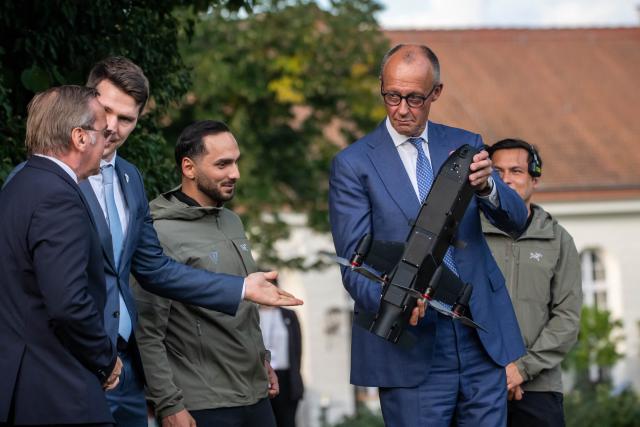 FILED - 25 August 2026, Brandenburg, Neuhardenberg: German Chancellor Friedrich Merz inspects an interceptor drone manufactured by Tytan next to Defense Minister Boris Pistorius during the federal government's closed-door meeting at Neuhardenberg Castle. Photo: Michael Kappeler/dpa