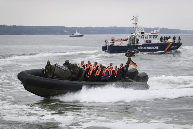 28 August 2026, Schleswig-Holstein, Flensburg: German Minister of the Interior Alexander Dobrindt (R), Parliamentary State Secretary to the Federal Minister of the Interior Christoph de Vries and the ministers and state secretaries of the Baltic Sea riparian states, take part in a ride on a Federal Police patrol boat as part of a visit to the patrol vessel "BP 82 Bamberg" during the Baltic Sea Security Summit at the Muerwik Naval Academy. Photo: Christian Charisius/dpa-Pool/dpa