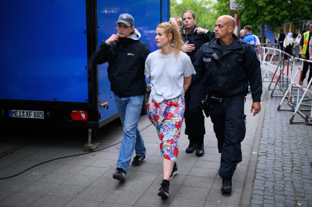 28 August 2026, Berlin: Police officers escort out a Femen activist who had attempted to disrupt the speech by Beatrix von Storch, the deputy chair of the AfD's Bundestag parliamentary group during an Alternative for Germany (AfD) campaign rally in Berlin-Lichtenberg. Photo: Bernd von Jutrczenka/dpa