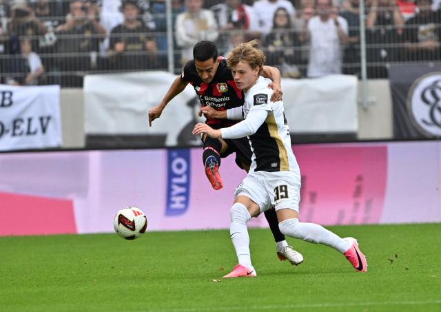 29 August 2026, Saarland, Spiesen-Elversberg: Elversberg's Cole Campbell (R) and Bayer Leverkusen's Lucas Vazques battle for the ball during the German Bundesliga soccer match between SV Elversberg and Bayer Leverkusen at Ursapharm-Arena an der Kaiserlinde. Photo: Harald Tittel/dpa - WICHTIGER HINWEIS: Gemäß den Vorgaben der Bundesliga bzw. des DFB Deutscher Fußball-Bund ist es untersagt, in dem Stadion und/oder vom Spiel angefertigte Fotoaufnahmen in Form von Sequenzbildern und/oder videoähnlichen Fotostrecken zu verwerten bzw. verwerten zu lassen.