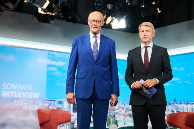 30 August 2026, Berlin: German Chancellor Friedrich Merz (L) stands in the studio ahead of the ARD (German public broadcaster) summer interview "Bericht aus Berlin," with host Markus Preiss. Photo: Annette Riedl/dpa