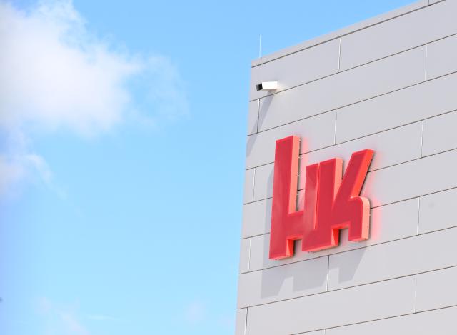 FILED - 10 July 2024, Baden-Württemberg, Oberndorf: FILE PHOTO - The logo of the firearms manufacturer Heckler & Koch is displayed on a building at its headquarters. Photo: Bernd Weißbrod/dpa