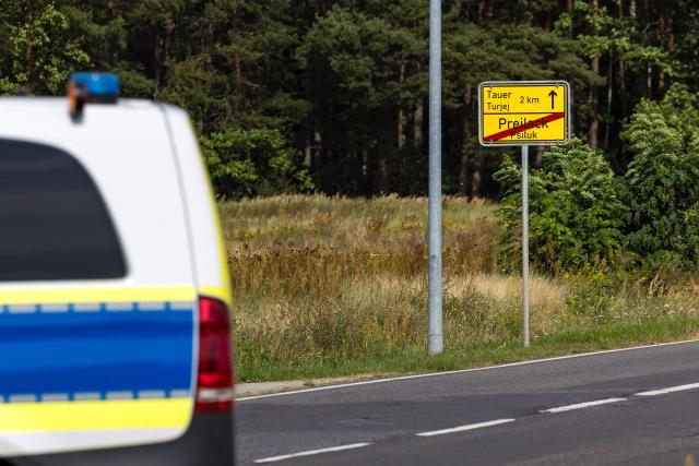 01 September 2026, Brandenburg, Turnow-Preilack: A police patrol car is parked in front of the town boundary sign for Preilack. Unconventional explosive devices were found today at the substation. Photo: Frank Hammerschmidt/dpa