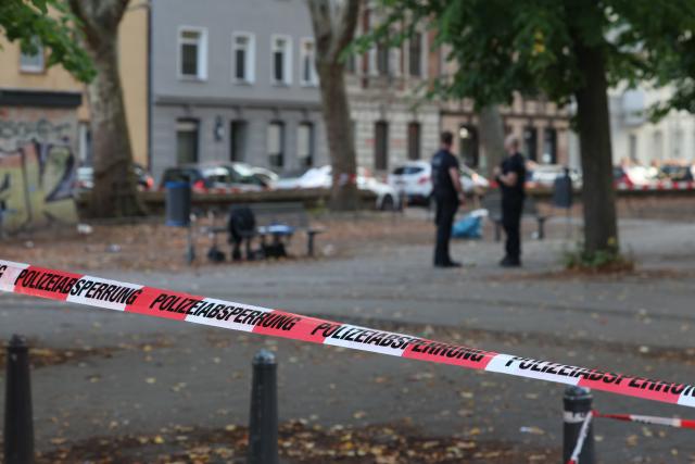 01 September 2026, North Rhine-Westphalia, Duisburg: Police officers secure the crime scene in front of St. Paul's Church after shots were fired during an altercation involving several people in Duisburg. Photo: Christoph Reichwein/dpa