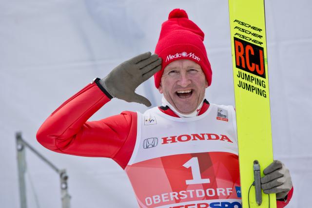 FILED - 29 December 2013, Bavaria, Oberstdorf: FILE PHOTO - Former ski jumper Michael Edwards, known as Eddie 'The Eagle', salutes during a show event at the first stage of the Four Hills ski jumping tournament in Oberstdorf. Photo: picture alliance / dpa