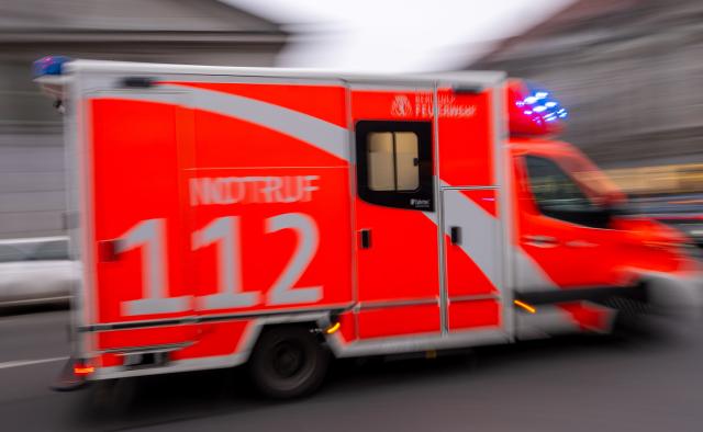FILED - 08 February 2024, Berlin: FILE PHOTO - An ambulance is responding to a call with its blue lights flashing. Photo: Monika Skolimowska/dpa