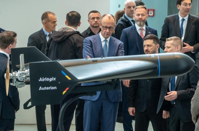 FILED - 14 April 2026, Berlin: File Photo - German Chancellor Friedrich Merz (C) inspects a drone alongside Volodymyr Zelensky (3-R), President of Ukraine, at an exhibition of German-Ukrainian co-productions at the Federal Chancellery on the occasion of the German-Ukrainian government consultations. Photo: Michael Kappeler/dpa