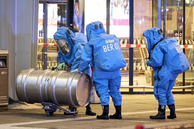 03 September 2026, Brandenburg, Schönefeld: Firefighters wearing chemical protection suits are on the scene in front of Terminal 1 at BER Airport, which was partially evacuated due to a potentially hazardous substance. Photo: Michael Ukas/dpa