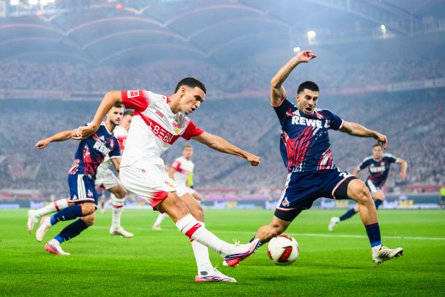 04 September 2026, Baden-Wuerttemberg, Stuttgart: Stuttgart's Bilal El Khannouss (L) and Cologne's Luka Lochoshvili battle for the ball during the German Bundesliga soccer match between VfB Stuttgart and 1. FC Koeln, at MHPArena. Photo: Tom Weller/dpa - IMPORTANT NOTICE: In accordance with the regulations of the Bundesliga and the DFB (German Football Association), it is prohibited to use or allow the use of photographs taken in the stadium and/or during the game in the form of sequential images and/or video-like photo series.