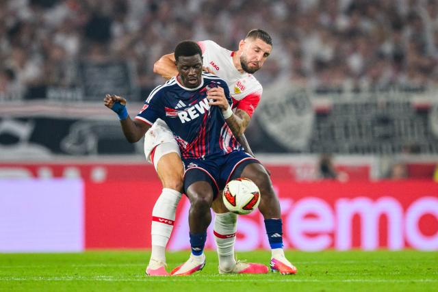 04 September 2026, Baden-Wuerttemberg, Stuttgart: Cologne's Ragnar Ache (front) and Stuttgart's Jeff Chabot battle for the ball during the German Bundesliga soccer match between VfB Stuttgart and 1. FC Koeln, at MHPArena. Photo: Tom Weller/dpa - IMPORTANT NOTICE: In accordance with the regulations of the Bundesliga and the DFB (German Football Association), it is prohibited to use or allow the use of photographs taken in the stadium and/or during the game in the form of sequential images and/or video-like photo series.