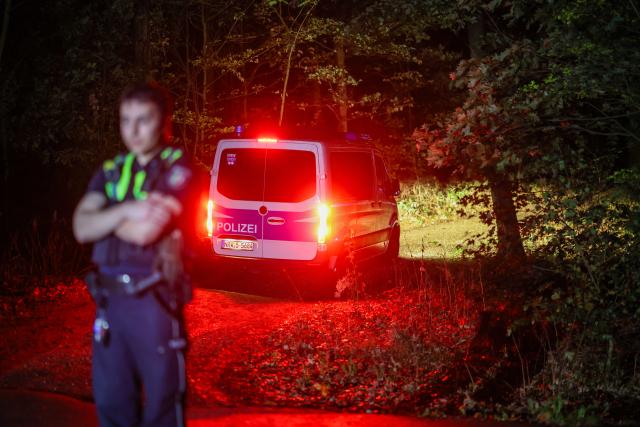 04 September 2026, North Rhine-Westphalia, Niederzier: A police officer secures the access to a forest near the suspect's truck, which was found there. According to NRW Interior Minister Reul, police raided the suspect's vehicle in connection with several acts of sabotage against the German power grid. Photo: Christoph Reichwein/dpa