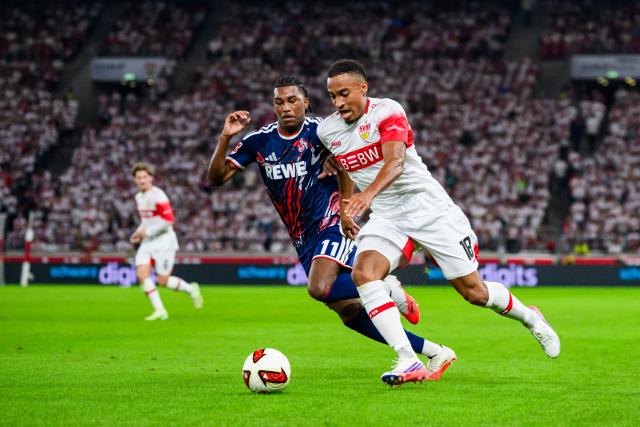 04 September 2026, Baden-Wuerttemberg, Stuttgart: Stuttgart's Jamie Leweling (R) and Cologne's Reigan Heskey battle for the ball during the German Bundesliga soccer match between VfB Stuttgart and 1. FC Koeln, at MHPArena. Photo: Tom Weller/dpa - IMPORTANT NOTICE: In accordance with the regulations of the Bundesliga and the DFB (German Football Association), it is prohibited to use or allow the use of photographs taken in the stadium and/or during the game in the form of sequential images and/or video-like photo series.