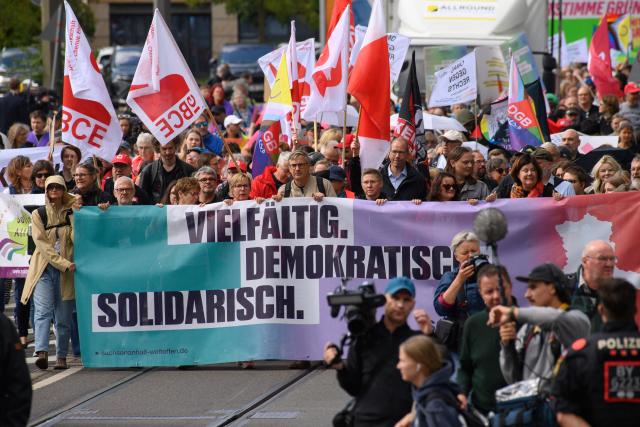 05 September 2026, Saxony-Anhalt, Magdeburg: Protesters march through the city center, carrying a banner that reads "Diverse. Democratic. United." The march began at the main train station and is heading to Domplatz, where a democracy festival organized by the coalition "Saxony-Anhalt. Open to the World" is taking place. Photo: Klaus-Dietmar Gabbert/dpa