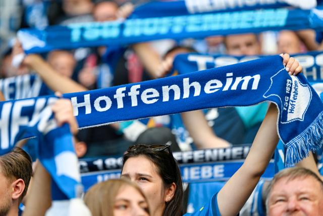 05 September 2026, Baden-Württemberg, Sinsheim: Hoffenheim fans hold up their scarves during the German Bundesliga soccer match between TSG 1899 Hoffenheim and Borussia Dortmund at the SNP Arena. Photo: Uwe Anspach/dpa - IMPORTANT NOTICE: In accordance with the regulations of the Bundesliga and the German Football Association (DFB), it is prohibited to use or allow the use of photographs taken in the stadium and/or during the game in the form of sequential images and/or video-like photo series.