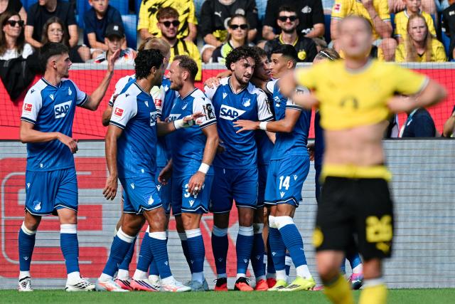 05 September 2026, Baden-Württemberg, Sinsheim: Hoffenheim's Leon Avdullahu (3rd R) celebrates scoring his side's first goal with teammates during the German Bundesliga soccer match between TSG 1899 Hoffenheim and Borussia Dortmund at the SNP Arena. Photo: Uwe Anspach/dpa - IMPORTANT NOTICE: Bundesliga and DFB regulations prohibit any use of photographs as image sequences and/or quasi-video.