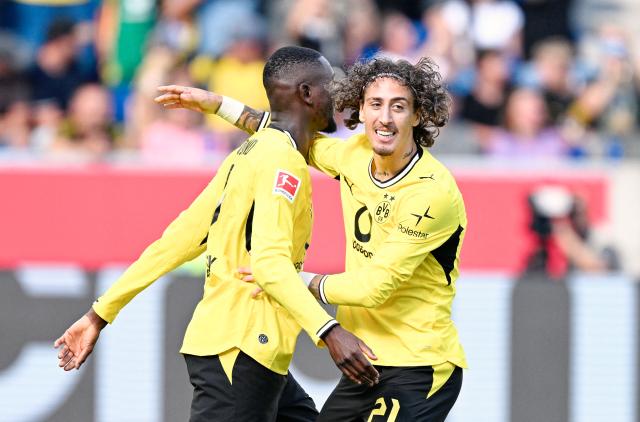 05 September 2026, Baden-Württemberg, Sinsheim: Dortmund's Fabio Silva celebrates scoring his side's second goal with teammate Serhou Guirassy during the German Bundesliga soccer match between TSG 1899 Hoffenheim and Borussia Dortmund at the SNP Arena. Photo: Uwe Anspach/dpa - IMPORTANT NOTICE: Bundesliga and DFB regulations prohibit any use of photographs as image sequences and/or quasi-video.