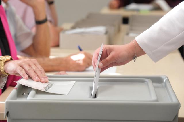 06 September 2026, Saxony-Anhalt, Magdeburg: A voter drops her ballot into a ballot box at a polling station. Saxony-Anhalt elects a new state parliament on Sunday. Photo: Klaus-Dietmar Gabbert/dpa