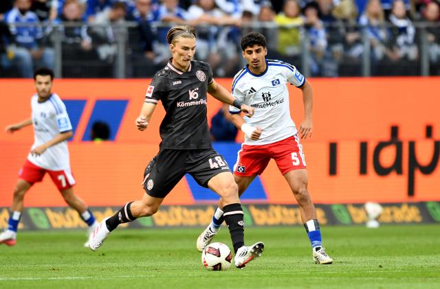 06 September 2026, Hamburg: Mainz's Kacper Potulski (L) and Hamburg's Martin Adeline battle for the ball during the German Bundesliga soccer match between Hamburger SV and FSV Mainz 05 at Volksparkstadion. Photo: Daniel Bockwoldt/dpa - WICHTIGER HINWEIS: Gemäß den Vorgaben der Bundesliga bzw. des DFB Deutscher Fußball-Bund ist es untersagt, in dem Stadion und/oder vom Spiel angefertigte Fotoaufnahmen in Form von Sequenzbildern und/oder videoähnlichen Fotostrecken zu verwerten bzw. verwerten zu lassen.