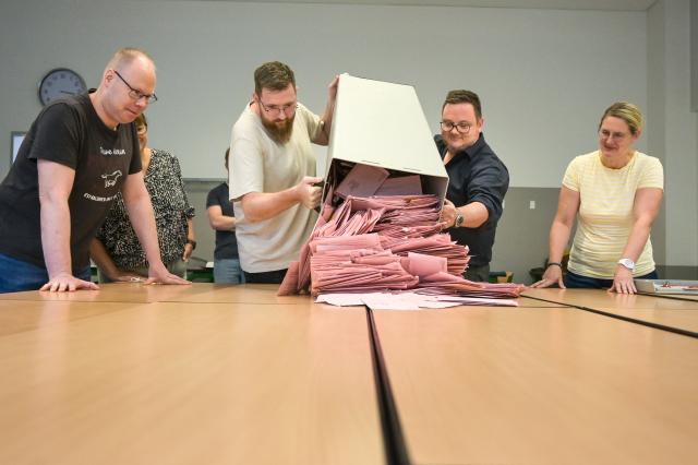 06 September 2026, Saxony-Anhalt, Magdeburg: Members of the election committee open the mail-in ballot boxes for the state election in Saxony-Anhalt. A new state legislature will be elected in Saxony-Anhalt on Sunday. Photo: Heiko Rebsch/dpa