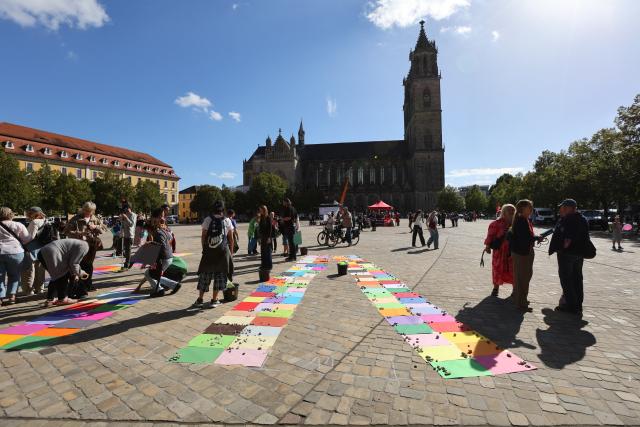 06 September 2026, Saxony-Anhalt, Magdeburg: Activists from Greenpeace, the DGB Youth, Solidarisches Magdeburg, and other organizations are protesting on Domplatz in support of democracy, a diverse society, solidarity, and humanity, on the day of the state election in Saxony-Anhalt. Photo: Matthias Bein/dpa