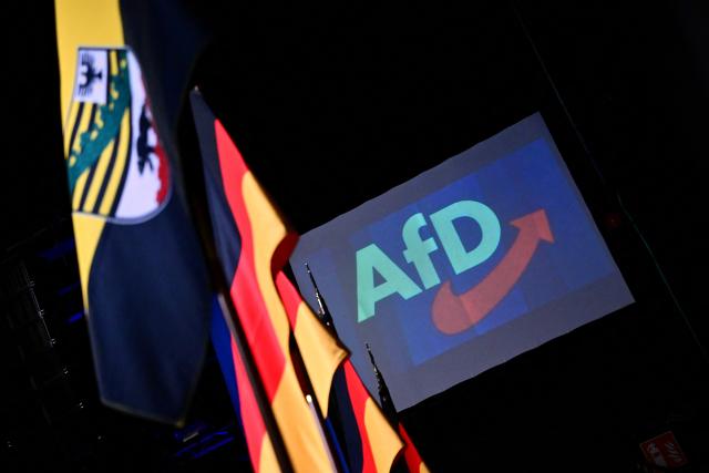 06 September 2026, Saxony-Anhalt, Magdeburg: German flags and the state flag of Saxony-Anhalt (L) are visible next to the AfD logo outside the Alternative for Germany (AfD) election party at the Altes Theater. A new state parliament will be elected in Saxony-Anhalt on Sunday. Photo: Sebastian Gollnow/dpa