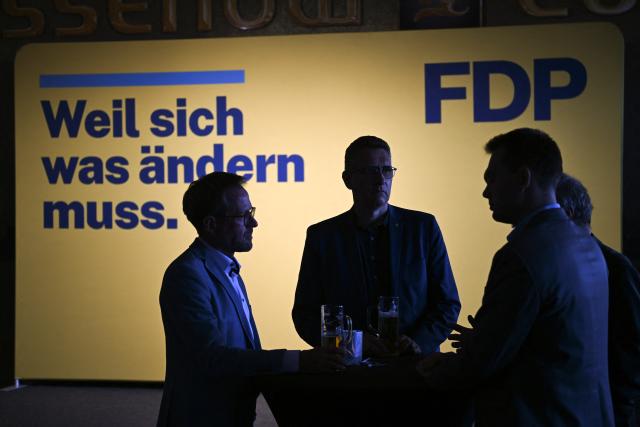 06 September 2026, Saxony-Anhalt, Magdeburg: People stand in front of a display that reads "Because things have to change" at the Free Democratic Party (FDP) election party. A new state parliament will be elected in Saxony-Anhalt. Photo: Hendrik Schmidt/dpa