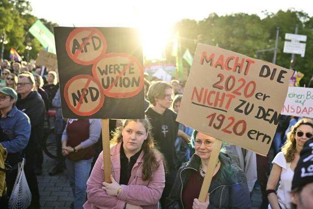 07 September 2026, Berlin: Two women hold hold signs during a rally at the Brandenburg Gate after the results of the Saxony-Anhalt state election, under the slogan "Time to Act: Stop the AfD!". Photo: Fabian Sommer/dpa