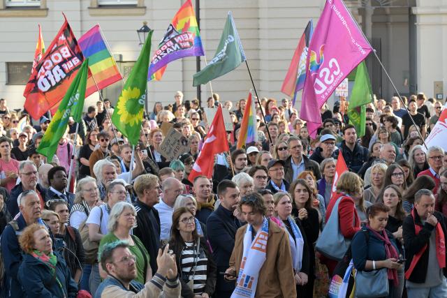07 September 2026, Brandenburg, Potsdam: People hold flags during a demonstration at the Old Market against the Alternative for Germany (AfD) electoral success in Saxony-Anhalt. Photo: Michael Bahlo/dpa