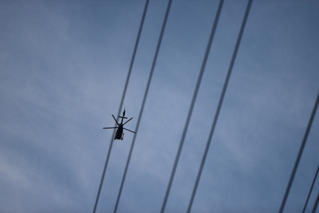 07 September 2026, North Rhine-Westphalia, Weisweiler: A helicopter flies over power lines. Following a series of acts of sabotage, the police have expanded their investigation and manhunt. Photo: str/dpa
