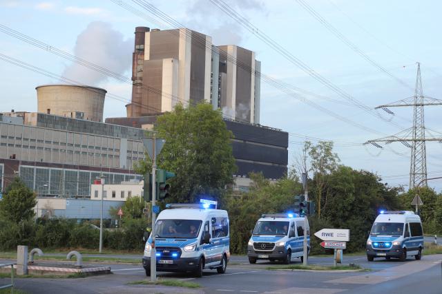 07 September 2026, North Rhine-Westphalia, Weisweiler: Police vehicles are driving along a road near the power plant under power lines. Following a series of acts of sabotage, the police have expanded their investigation and manhunt. Photo: str/dpa