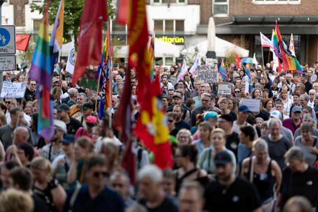 07 September 2026, North Rhine-Westphalia, Essen: Demonstrators hold signs during a march through downtown Essen in response to the Alternative for Germany (AfD) strong showing in the state legislative elections in Saxony-Anhalt. Photo: Fabian Strauch/dpa
