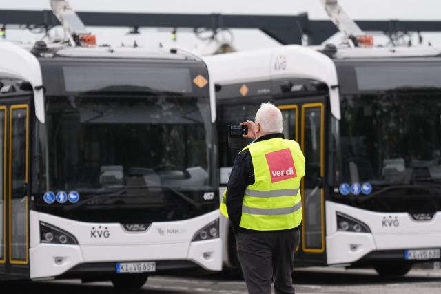 08 September 2026, Schleswig-Holstein, Kiel: A striking employee takes photos of the parked buses in the KVG Kieler Transport company depot. The Verdi service workers' union has called for a warning strike in local public transportation in some cities. Photo: Marcus Brandt/dpa