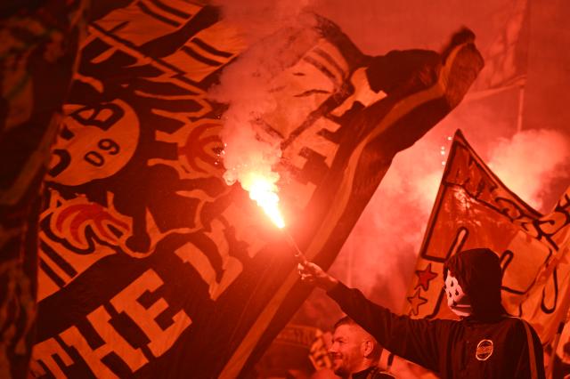 08 September 2026, North Rhine-Westphalia, Dortmund: A masked fan holds pyrotechnics prior to the start of the UEFA Champions League group stage soccer match between Borussia Dortmund and Villarreal CF at Signal Iduna Park. Photo: Bernd Thissen/dpa