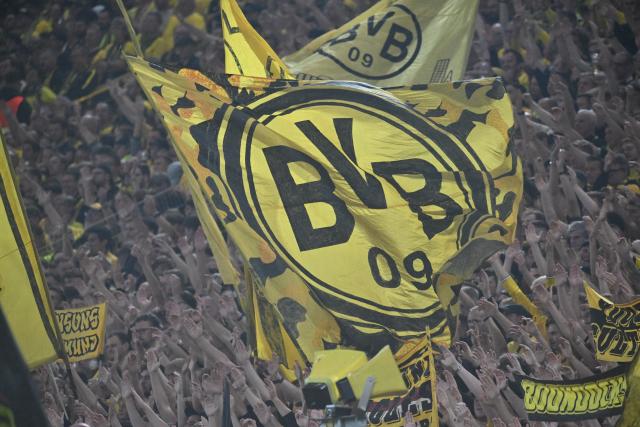 08 September 2026, North Rhine-Westphalia, Dortmund: A flag bearing the Borussia Dortmund logo is being waved in the fan section during the UEFA Champions League group stage soccer match between Borussia Dortmund and Villarreal CF at Signal Iduna Park. Photo: Bernd Thissen/dpa