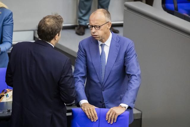 09 September 2026, Berlin: Germany's Chancellor Friedrich Merz (R) and Lars Klingbeil, Germany's Minister of Finance and co-chair of the Social Democratic Party (SPD), speak with each other before the general debate during budget deliberations in the German Bundestag. Photo: Christoph Soeder/dpa