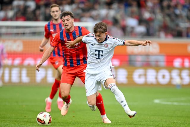 FILED - 18 August 2026, Baden-Wuerttemberg, Heidenheim: FILE PHOTO - Heidenheim's Luca Kerber (L) and Bayern Munich's Tim Binder battle for the ball during the Club Friendly soccer Match between 1. FC Heidenheim and FC Bayern Munich. Photo: Harry Langer/dpa - WICHTIGER HINWEIS: Gemäß den Vorgaben der Bundesliga bzw. des DFB Deutscher Fußball-Bund ist es untersagt, in dem Stadion und/oder vom Spiel angefertigte Fotoaufnahmen in Form von Sequenzbildern und/oder videoähnlichen Fotostrecken zu verwerten bzw. verwerten zu lassen.