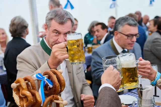 09 September 2026, Berlin: Minister-President of Bavaria Markus Soeder (L) sits next to Head of the Bavarian State Chancellery and Minister of State for Federal Affairs and Media Florian Herrmann in a beer tent at the traditional Berlin kickoff of the Munich Oktoberfest at the "Tipi am Kanzleramt." Photo: Annette Riedl/dpa
