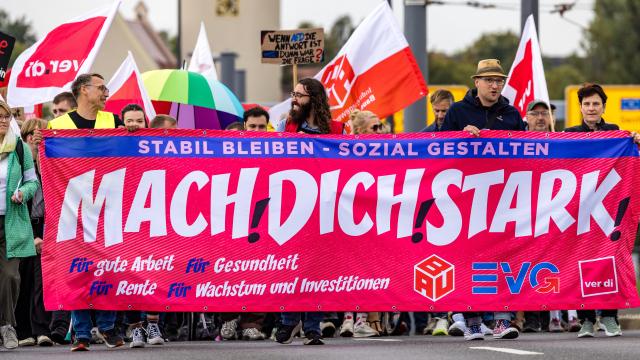 12 September 2026, Brandenburg, Cottbus: Participants in a labour union demonstration march through the city centre behind a banner reading "Be Strong". Members of the ver.di, BAU and EVG labour unions are demonstrating under the slogan "Enough Is Enough" against planned social cuts in Germany. Photo: Frank Hammerschmidt/dpa